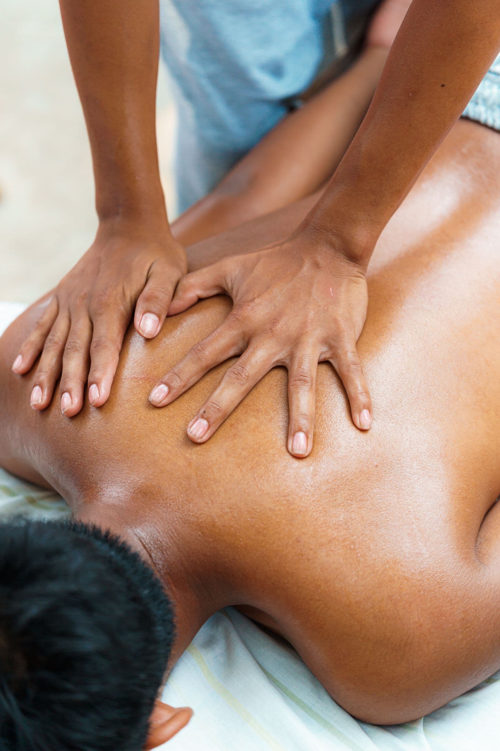 Body-to-body massage — oiled skin, close-contact hands on back